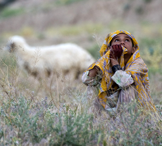 A young Afghan girl observes as Coalition aircraft provide aerial security during a village clearing operation in northern Khakrez district, May 25, 2011, Kandahar province, Afghanistan. Operations such as these, conducted by Afghan Commandos with the Afghan National Army’s 3rd Commando Kandak and U.S. Navy SEALs with Special Operations Task Force – South, help legitimize the Government of Afghanistan and hinder Taliban influence in the area. Also assisting during the operation were members of the Afghan National Police and Ghorak District Chief of Police, Alam Guhl. (U.S. Army photo by Sgt. Daniel P. Shook)(Released).