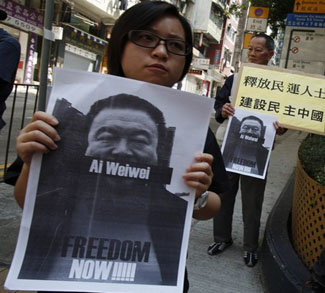 Pro-democracy protesters carry portraits of detained Chinese artist Ai Weiwei in Hong Kong