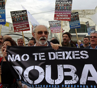 People protest in front of Finance Ministry holding a banner saying 