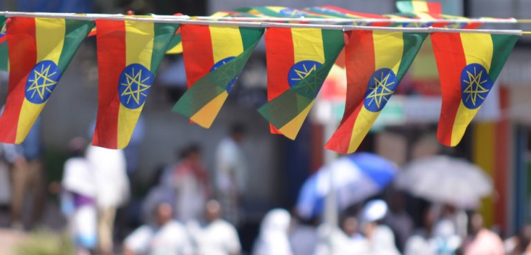 EthiopiaFlag, cc Flickr John Iglar, modified, https://creativecommons.org/licenses/by-sa/2.0/