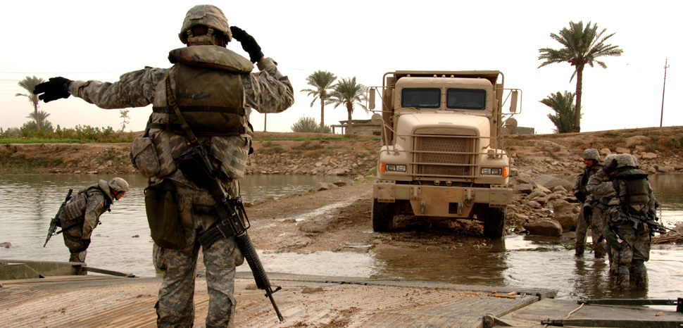 cc Flickr The U.S. Army, modified, U.S. Army Soldiers from the 20th Engineer Brigade shuttle trucks across the Euphrates River Nov. 16, 2007, in support a combat operation near Baghdad, Iraq. (U.S. Army photo by Spc. Luke Thornberry) www.army.mil, https://creativecommons.org/licenses/by/2.0/